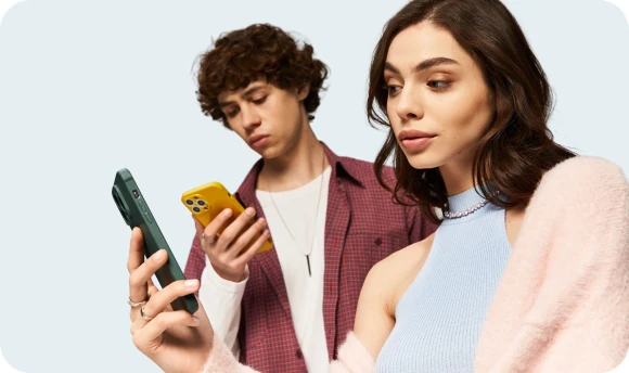 Young man and woman looking at their phones