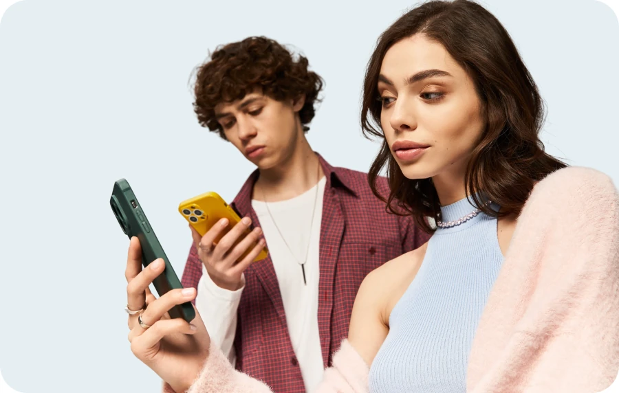 Young man and woman looking at their phones