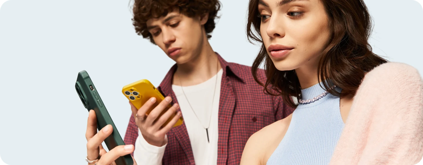 Young man and woman looking at their phones