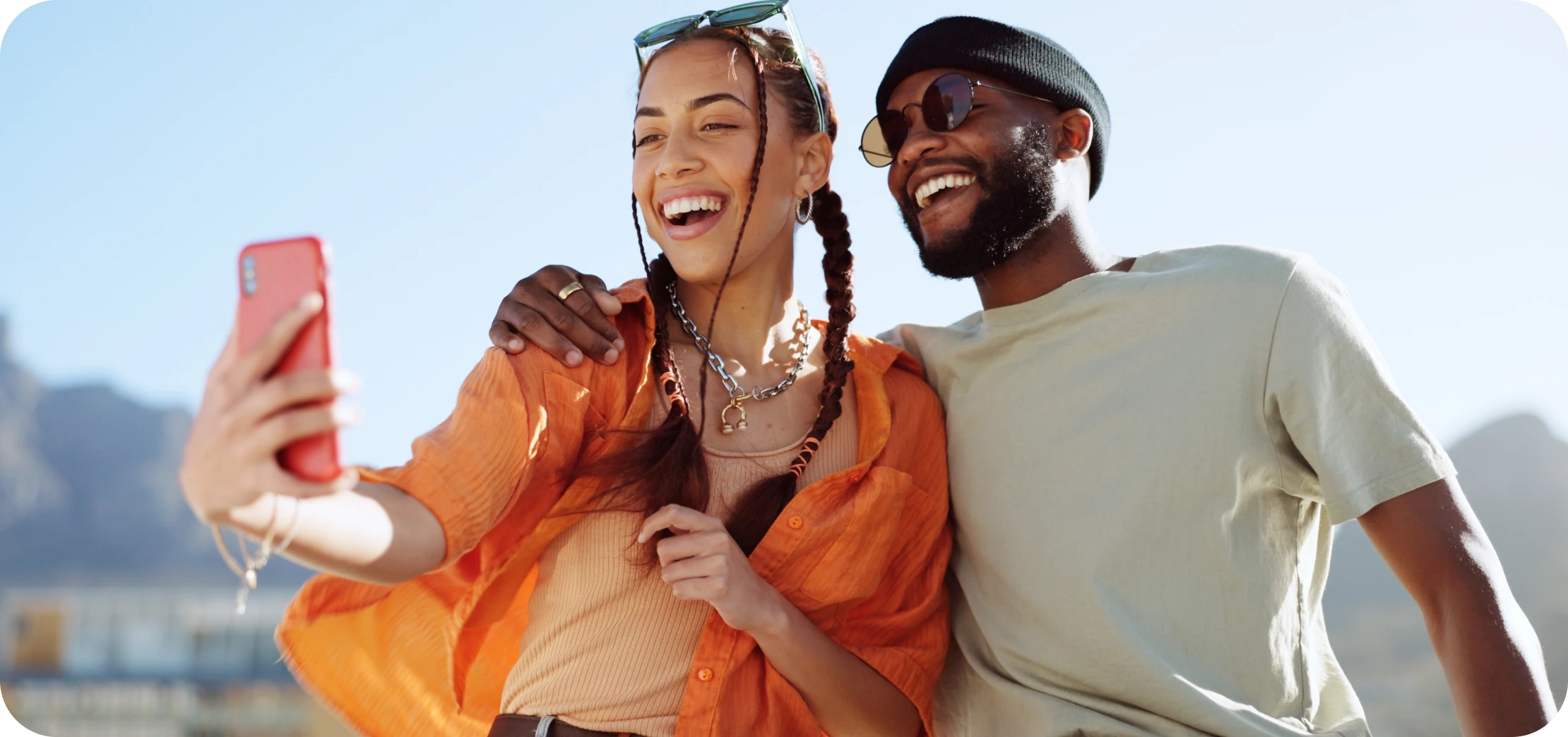 Laughing couple taking a selfie outdoors